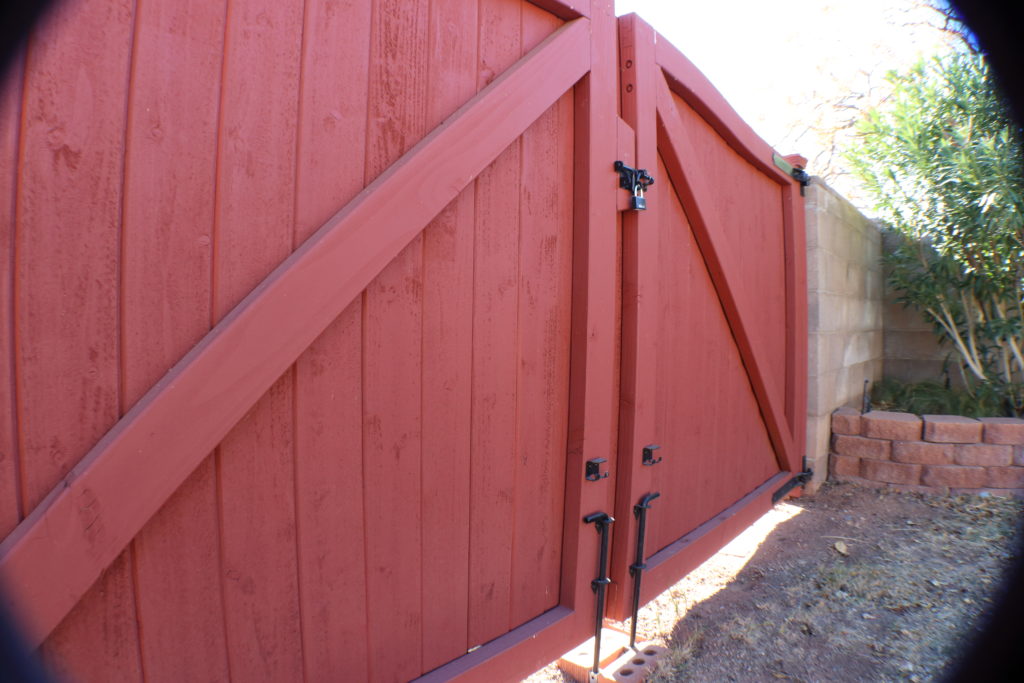 Two large wooden gates align perfectly where they meet.