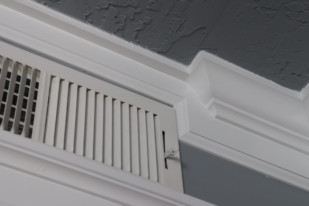 Crown moulding returns create visual interest when working around this HVAC vent.