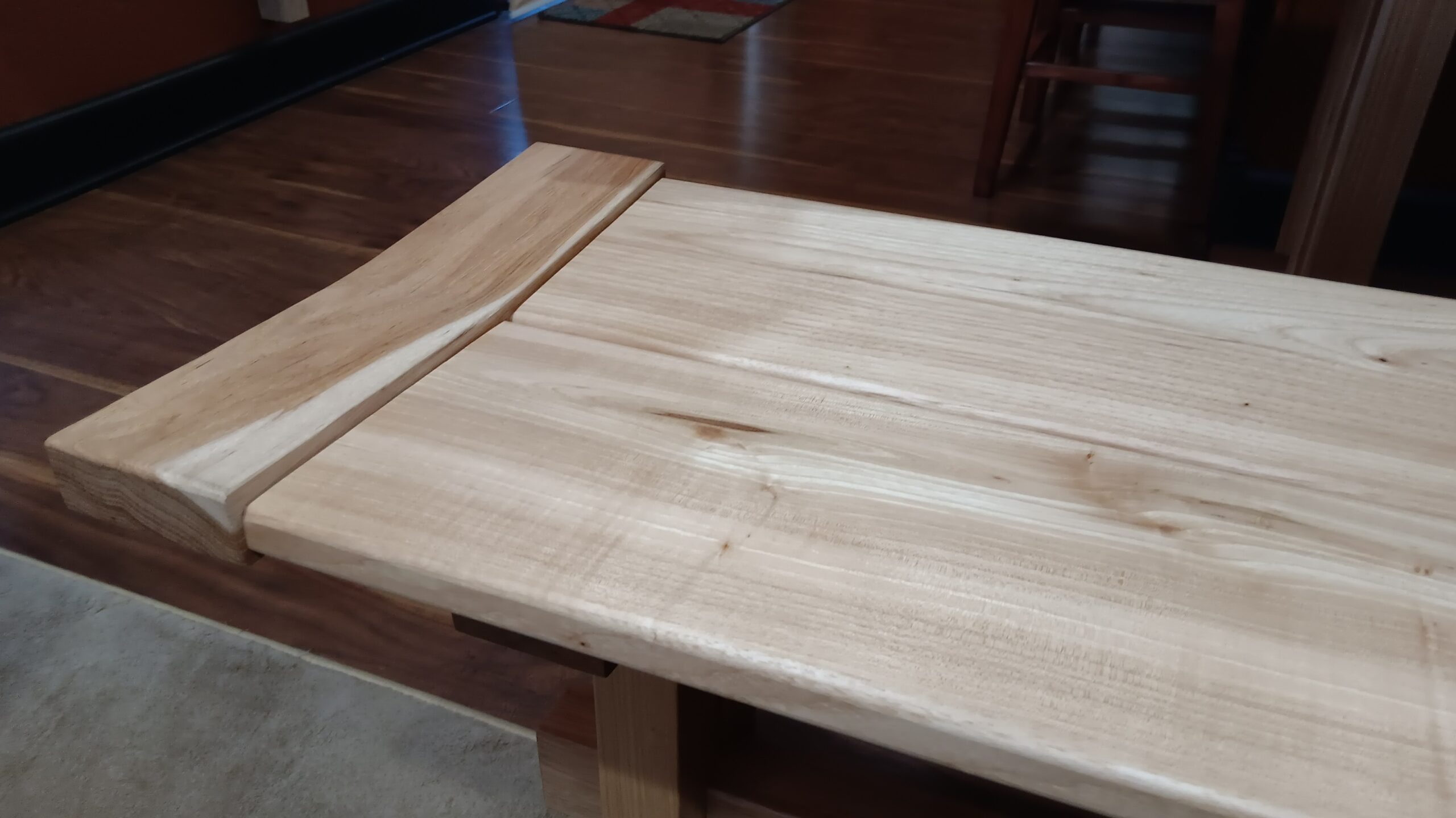 This angel-wing breadboard end positions the bench planks to create a comfy seat.